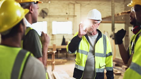 construction workers discussing work in a warehouse