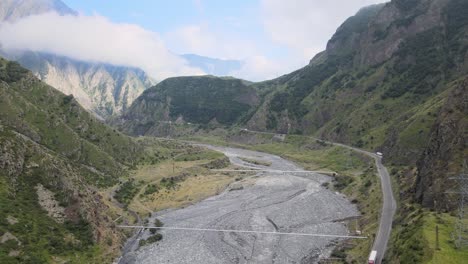 Aerial-shot-of-valley-road-mountains-fog-and-cloud-caucasian-mountains