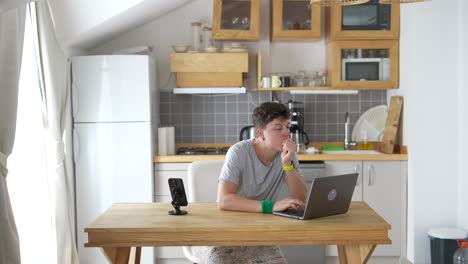 person working on a laptop in a kitchen