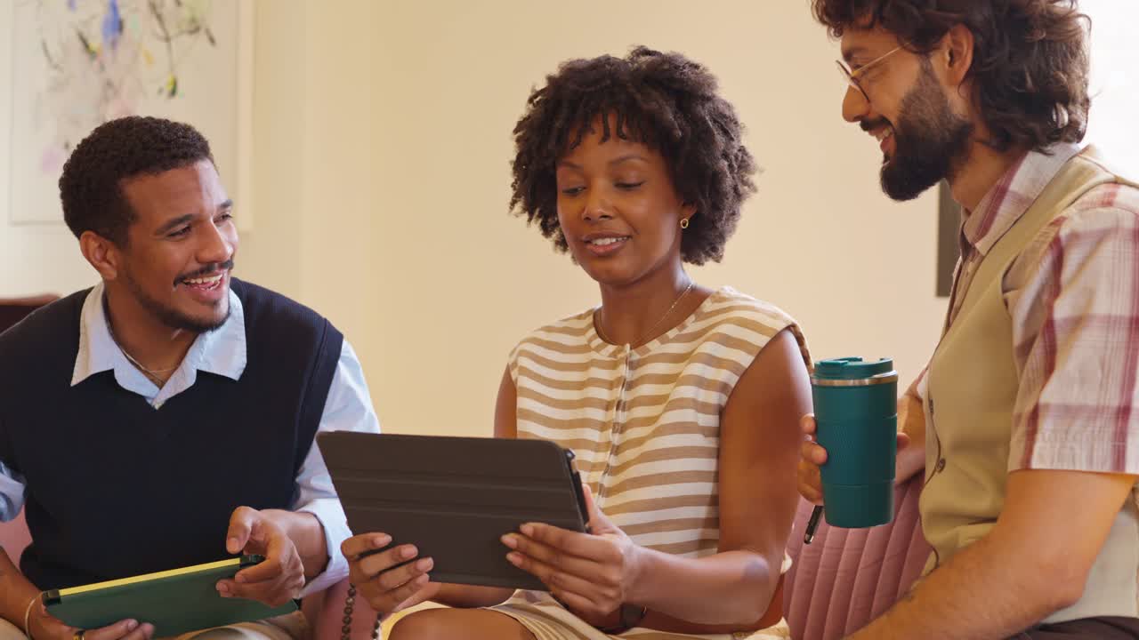 A business meeting with diverse coworkers using a tablet to discuss work