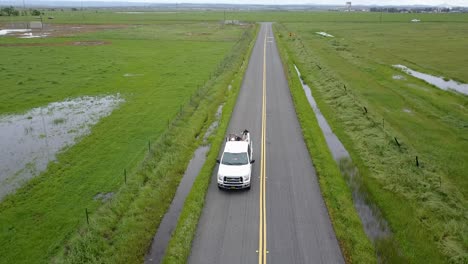 truck drives along a country road