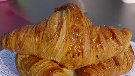delicious freshly baked butter french croissants outside in early morning light ready to eat. european breakfast cuisine close up 4k