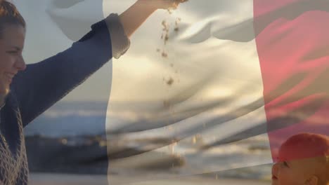 Animation-of-flag-of-france-over-happy-caucasian-mother-with-child-playing-at-beach