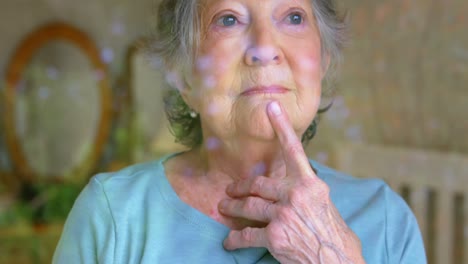 senior woman looking through the window 4k