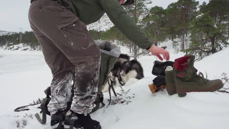 a man doubles up his socks and switches his shoes during winter in bessaker, trondelag county, norway - static shot