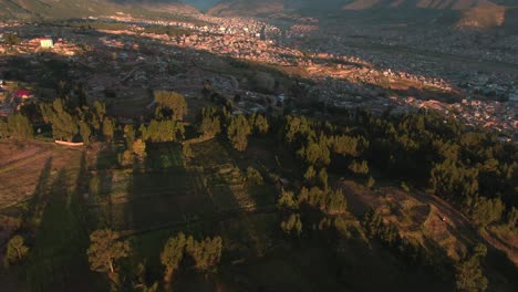 4k aerial drone footage over the lush green hills and mountains in the northern side of cusco in peru at sunset