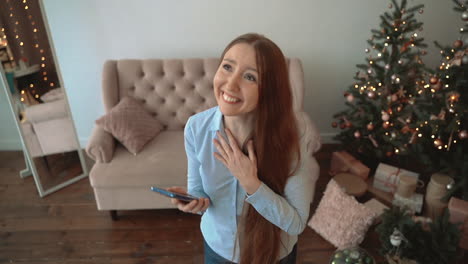 excited woman using a phone at home