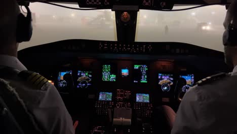 jet cockpit view inside in a heavy fog codition in the airport ramp at night