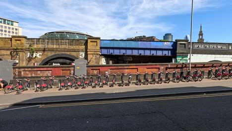 traffic and pedestrians near a bridge in london