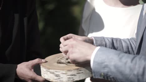 couple tying a knot during a rustic wedding ceremony