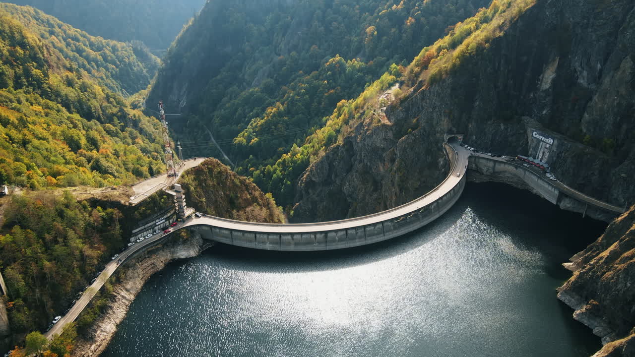 Aerial drone view of nature in Romania. Valley in Carpathian mountains with Vidraru dam and lake, slopes with lush forest