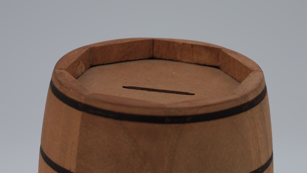 Wooden barrel-shaped money box close-up