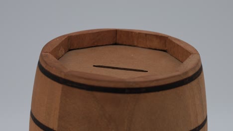 wooden barrel-shaped money box close-up