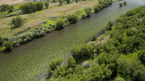 Aerial-Fly-Over-Pan-Up-Reveal-Drone-Footage-over-Madison-River-in-Montana,-USA