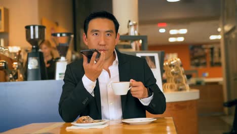 businessman with coffee while talking on mobile phone 4k