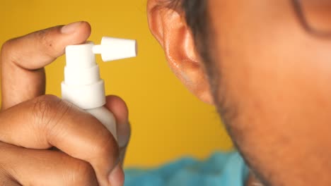 applying ear spray