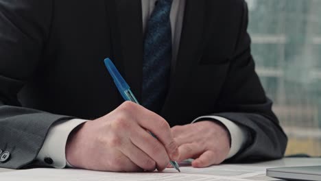 businessman taking notes or signing contract, pen and document, man in formal jacket. close up hand