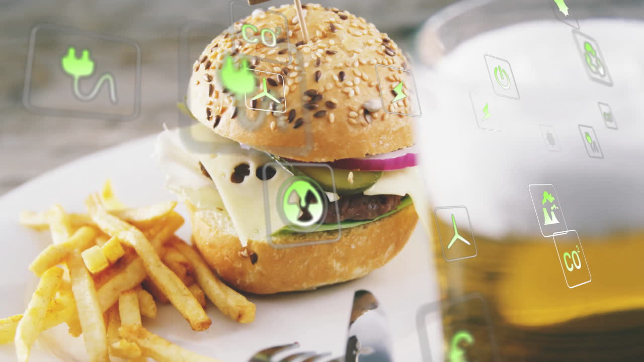 Burger and fries on plate with eco-friendly icons overlay animation