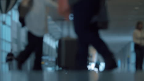 people with luggage in airport hall defocus