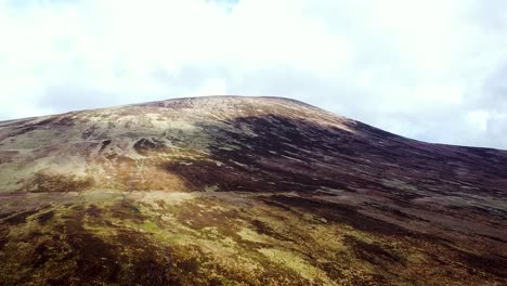 aerial drone shot of the mountainous topography and arid landscape at the foothills of the wicklow mountains in dublin, ireland