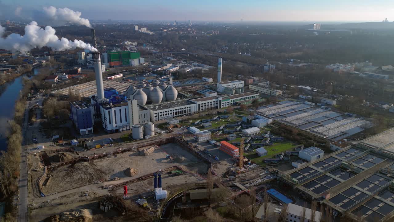 Wastewater treatment plant purifying urban water showing sedimentation tanks, aeration tanks and clarifiers. Wonderful aerial view flight static tripod hovering drone