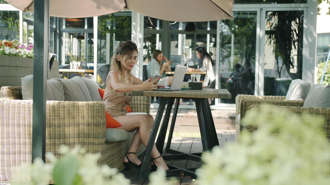 야외 카페 에서 노트북 을 사용 하는 여자