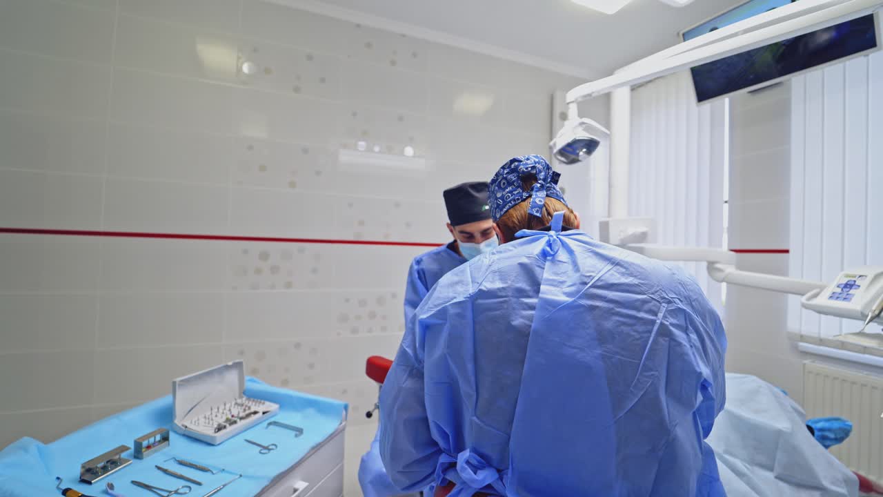 Dentist with assistant work in dental clinic. Dentist and assistant carried out the tooth of the patient