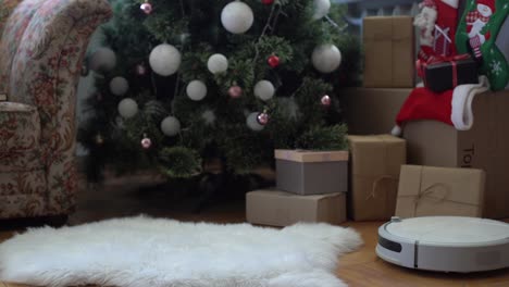 Smart-home.-Robot-vacuum-cleaner-performs-automatic-cleaning-of-the-apartment-at-a-certain-time.-Cleans-the-parquet-from-Christmas-tree-needles-after-the-new-year.