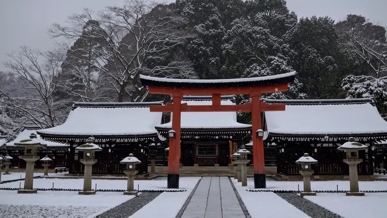 A serene winter scene of a snow-covered Japanese shrine captured from a low angle