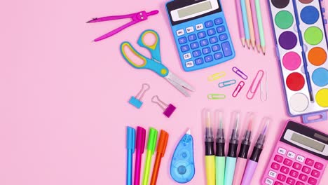 pastel vibrant back to school accessories appear on pastel pink theme. stop motion
