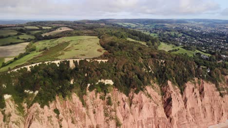 aerial view of coastal jurassic cliffs east devon england slow dolly back, establishing shot