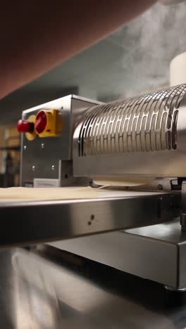 automated dough sheeting machine in action