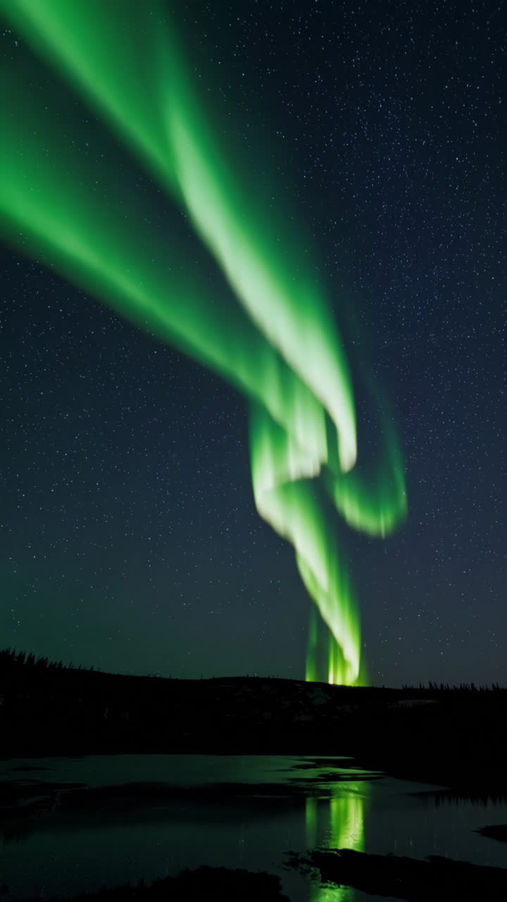 Spectacular Green Aurora Borealis Reflecting on Water at Night