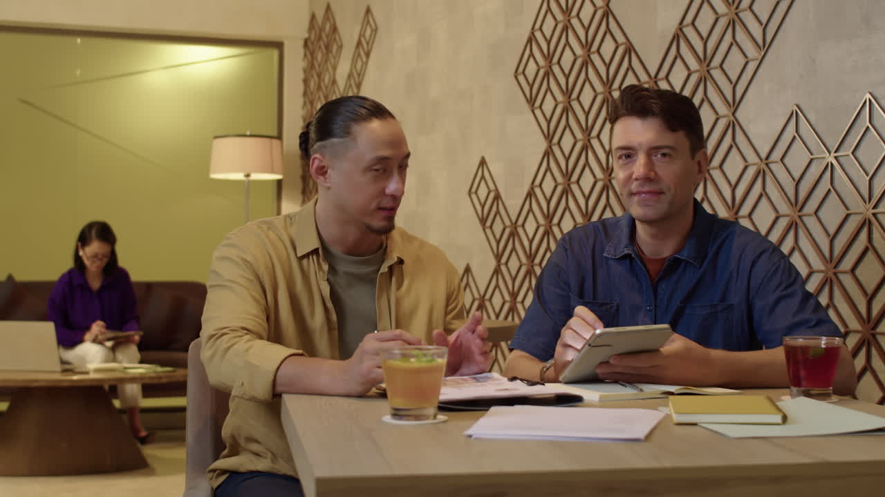 Portrait of Multiracial Entrepreneurs Working at Table with Documents