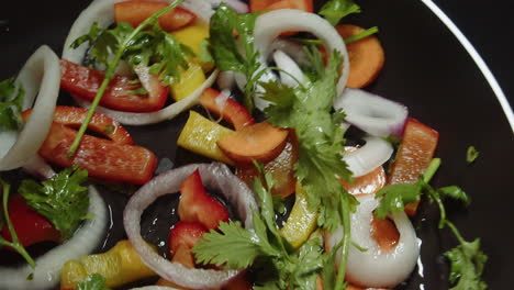 shuffling, chopped vegetables in the pan