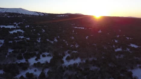 winter sunset over snowy mountain forest