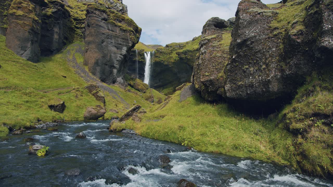 Iceland beautiful remote ravine with Kvernufoss watterfall. Colorful outdoor mountain scene of nature