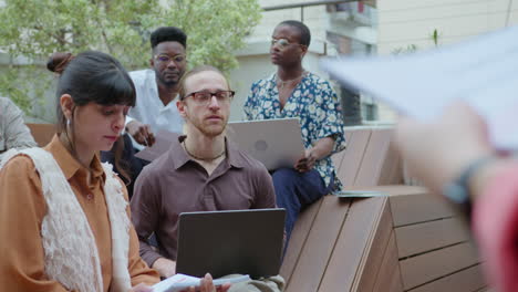 multi-ethnic business team having meeting on outdoor terrace