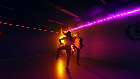 couple dancing in a neon-lit club