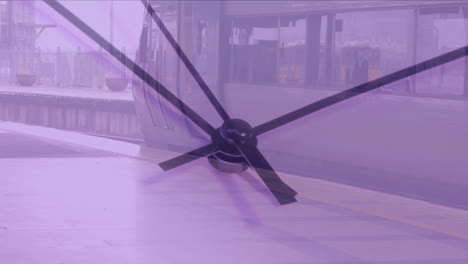 video compuesto de un primer plano de un reloj de tic-tac contra un tren detenido en una estación de tren