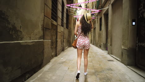 woman walking down a barcelona alley