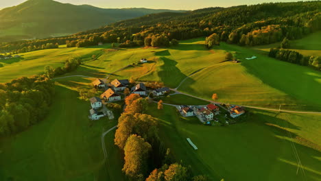 aerial shot of a scenic rural landscape with a small village at sunset