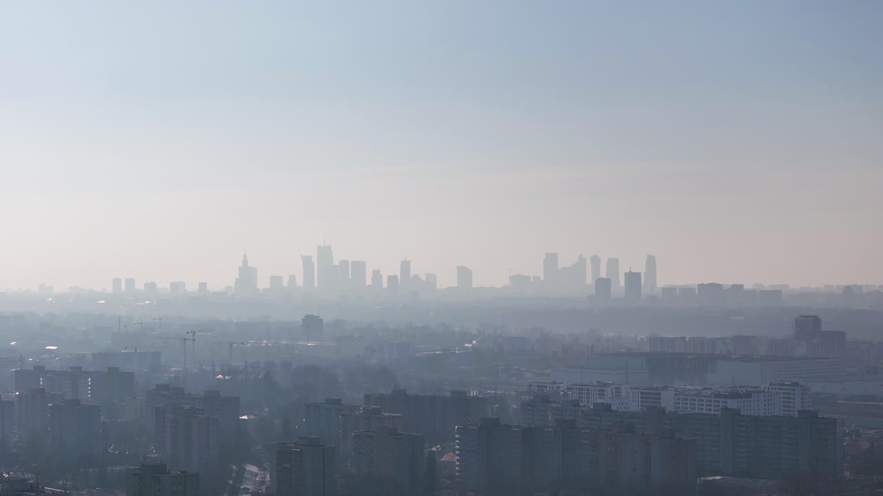 Warsaw skyline silhouette seen in a cloud of pollution. Aerial view