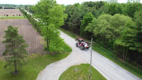 sprayer machine leaving driveway and heading out to farm