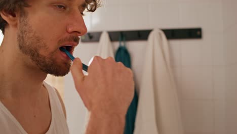 man brushing his teeth