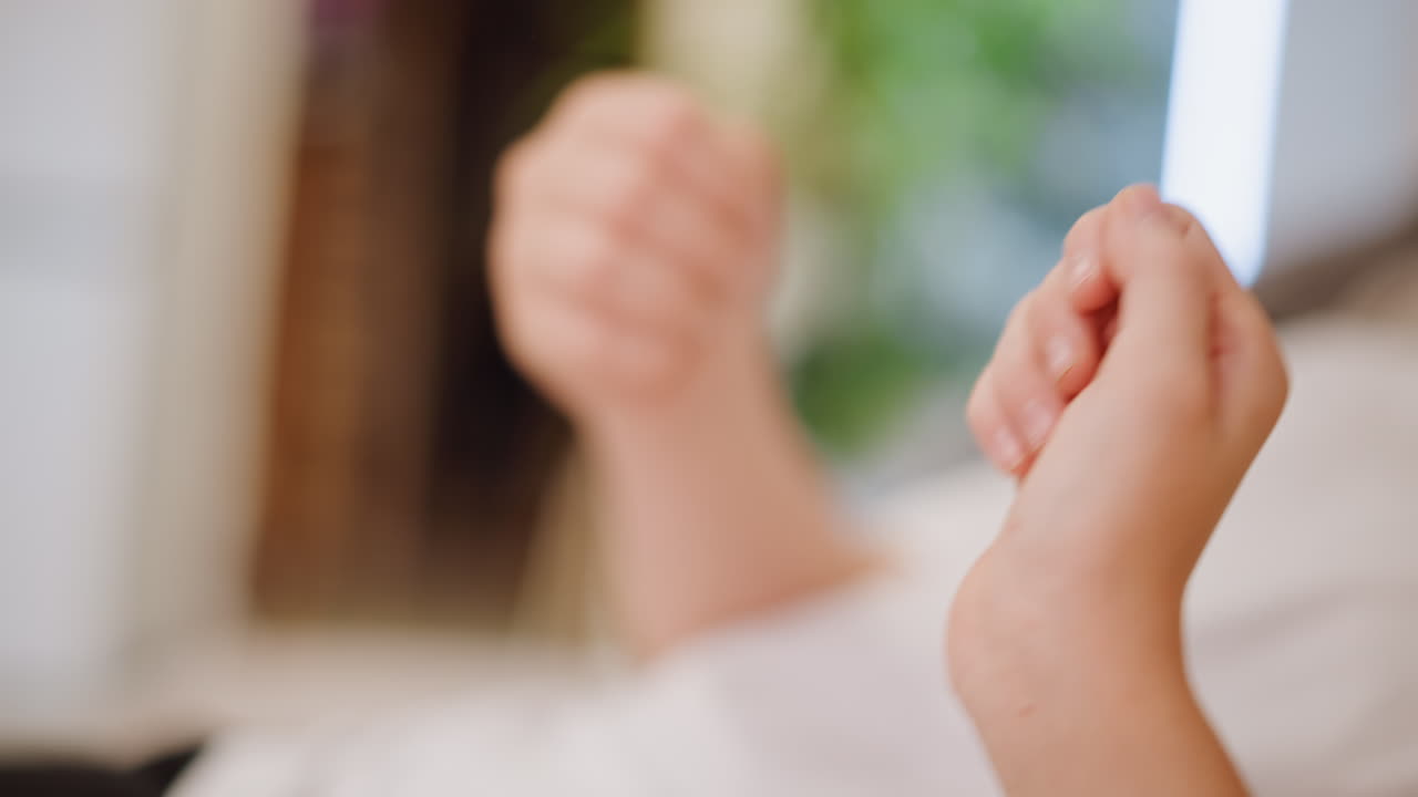 Young child practices rhythm with hand signs. Closeup of child performing clapping and signing exercises. An adorable child engages in counting and rhythm activities with gentle hand movements