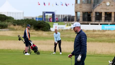 golfers walking on the field at st andrews