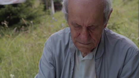 Old-man-working-in-garden,-close-up