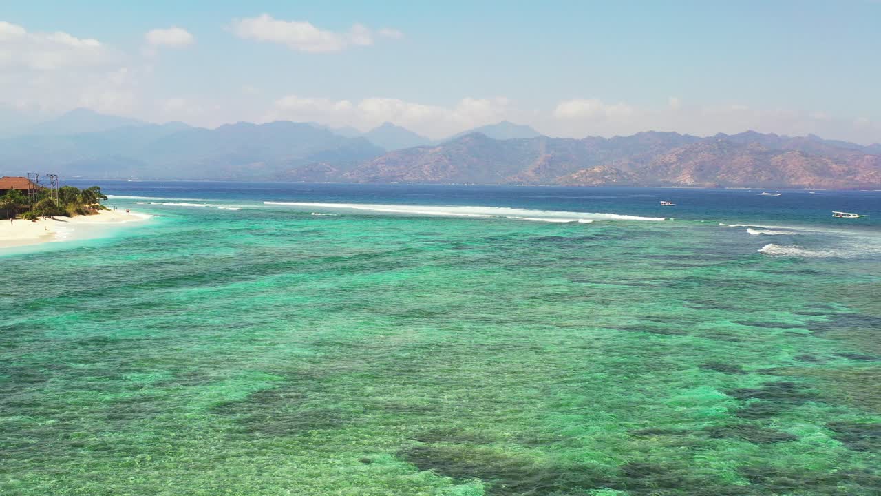 Beautiful patterns of coral reefs and rocks underwater on turquoise lagoon around white sandy beach of tropical island, Bali