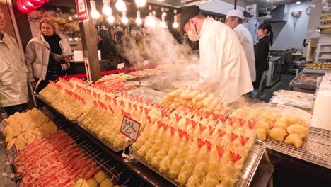 chefs preparing food at a bustling market stall